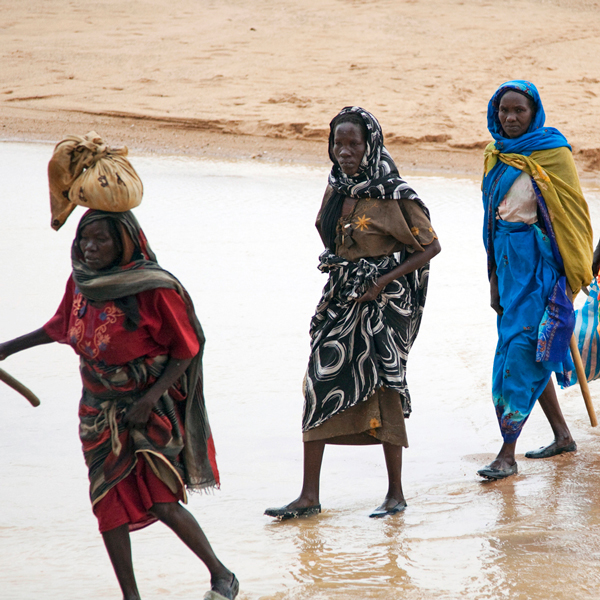 Women walking through a shallow river