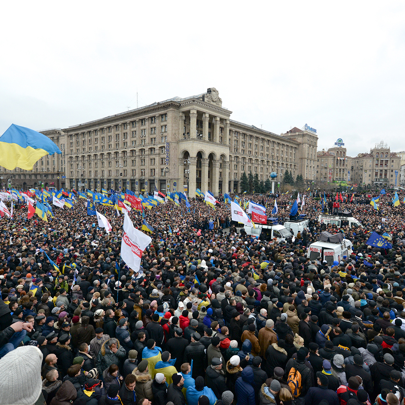 Large crowd of protestors, many holding flags, in Maidan Square in Kiev