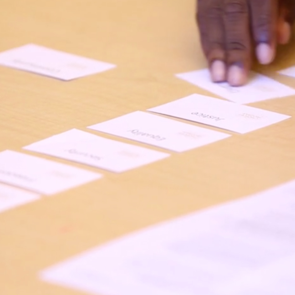 Person putting paper squares in a column