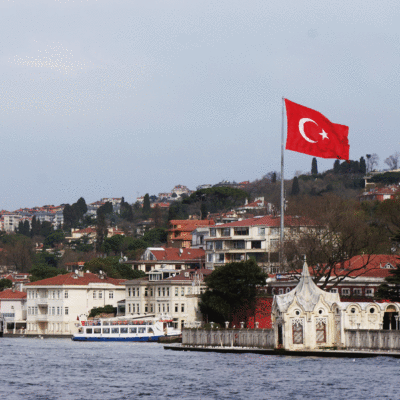 Buildings in Istanbul and the flag of Turkey on the banks of the Bosphorus strait