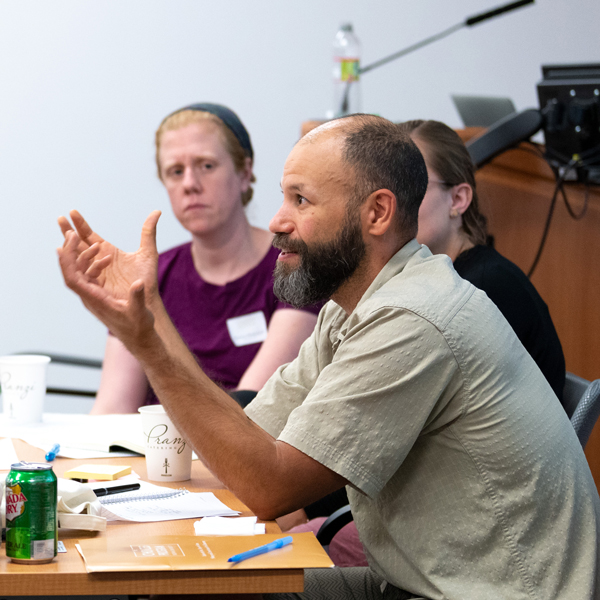 Man sitting at a desk and speaking at a Choices workshop