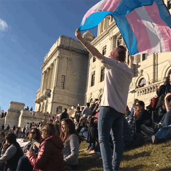 People sitting in front of the Providence statehouse at a Trans rights protest