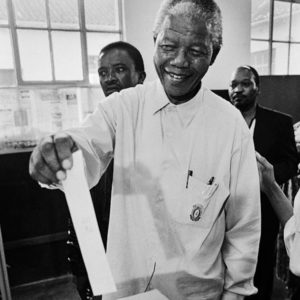 Nelson Mandela putting a ballot into a ballot box