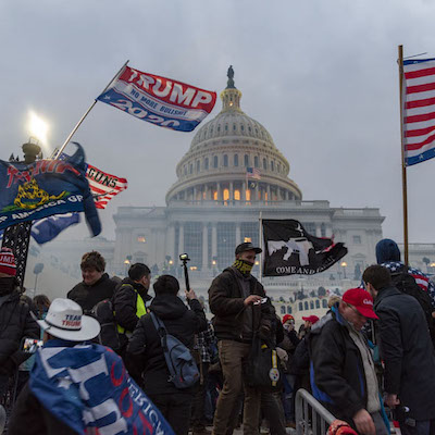 January 6 rioters waving Trump flags in front of the Capitol building