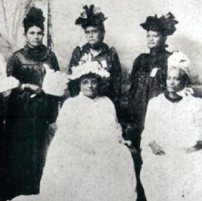 Collage of African Americans sitting in a meeting; Black and white photo of members of the Hawaiian Patriotic League for Women pose in two rows, one seated and one standing; most wear fancy dresses and ornate hats/headpieces; and several Japanese Americans wearing business clothing and standing in what appears to be a greenhouse