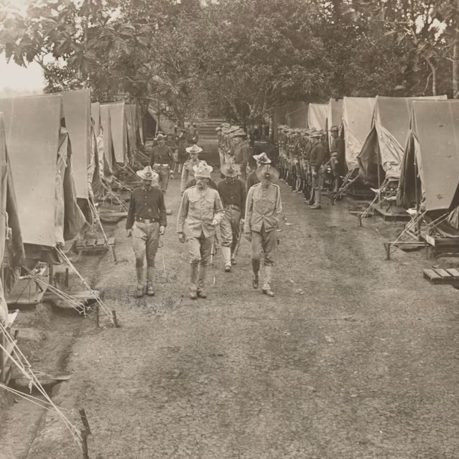 Soldiers walk between rows of tents of U.S. troops occupying Panama to secure its independence from Colombia, 1904.